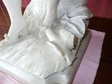 a statue of a woman sitting on top of a table