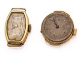 an image of two watches sitting next to each other on a white surface