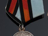two medals and a medal on a black background