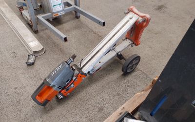 a small scissor sitting on the ground next to a dolly