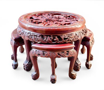 three stools and a table with carvings on them
