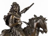bronze statue of a man riding a horse with a sword in his hand