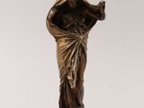 a bronze statue of a woman with a veil on her head