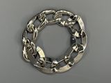 silver plated chain bracelet on grey surface with silver clasp