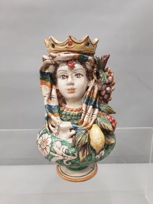 un buste en céramique représentant une femme coiffée d'une couronne