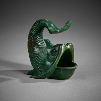 a close up of a green sculpture of a fish with its mouth open