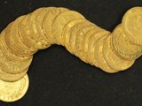 a pile of gold coins sitting on a black surface