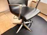 a black chair sitting on top of a black mat