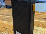 a small black device sitting on a wooden table