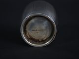 an image of a close up of a metal cup on a black surface