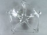 a clear glass star shaped object on a table
