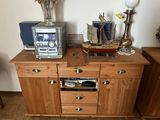 a microwave sitting on top of a wooden cabinet