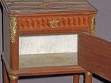 a small wooden table with a drawer on top of it