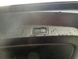 a close up of a car ' s dashboard button with water droplets on it