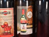 three bottles of wine are lined up on a shelf