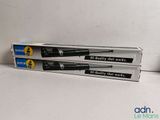 two black and white pens are sitting on top of a white table