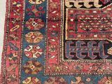 an old persian rug with many different colors and patterns