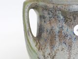 a close up of a cup with a tag on it