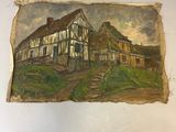 peinture représentant une vieille maison sur une feuille de papier posée sur une table