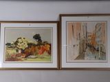 two paintings hanging on the wall above a bed