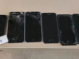 four iphones are sitting on a table with a price tag on them