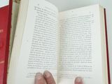 a person holding an open book in their hand