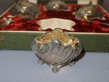 a silver bowl in a red velvet box on a table