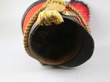 a red and black pipe with a gold decoration on it