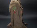 a brown jacket with a green leaf on the chest and a red rose on the chest