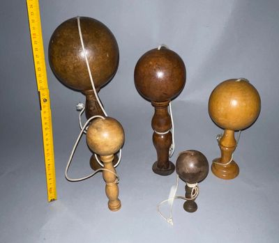three wooden balls and a measuring tape are on a table