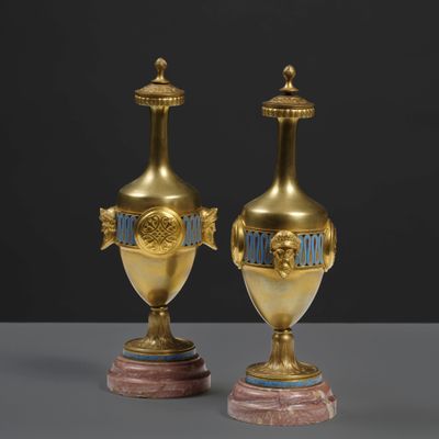 pair of antique brass vases with blue and gold decoration on marble bases