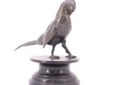 a statue of a bird on a pedestal on a white background