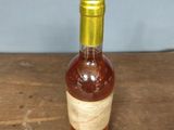 a bottle of alcohol sitting on a wooden table