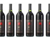 six bottles of wine are lined up in a row