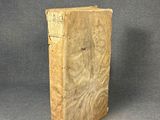 an old book sitting on top of a table next to a gray background