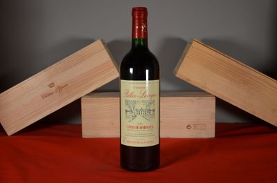 a bottle of wine sitting on a table next to two wooden boxes