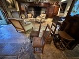 a living room with a fireplace, chairs, and a piano