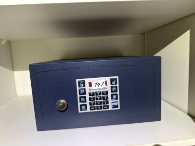 a blue safe box sitting on a shelf in a room