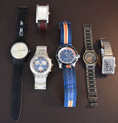 a lot of watches that are sitting on a table