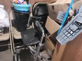 a pile of boxes and a chair in a room