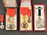 three medals and a medal are in a box on a table