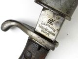 an old knife with a metal handle on a white surface