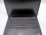 a black laptop with a red button on the keyboard