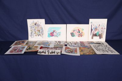 a table topped with lots of cards on top of a blue cloth
