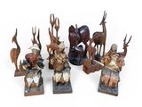 several wooden figurines of animals and people with antelope