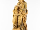 a statue of a woman holding a child in her lap