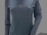 a female mannequin wearing a blue shirt and black pants