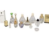 many different bottles of perfume sitting on a white surface