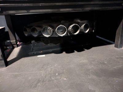 a black oven with four burners on it in the kitchen