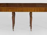 une table à manger ovale à deux pieds, avec un plateau en bois